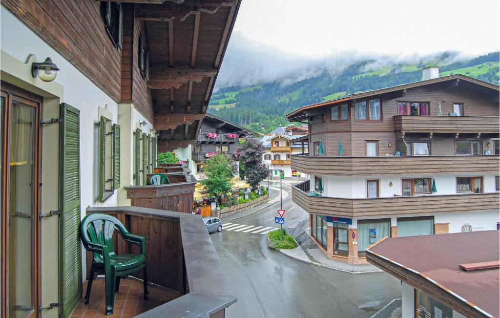 a balcony with a chair and a view of a city at Gorgeous Studio In Kirchberg With House A Mountain View in Kirchberg in Tirol