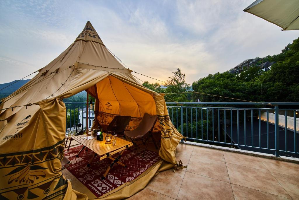 a large tent sitting on a balcony at Wind comes from Westlake B&B in Hangzhou