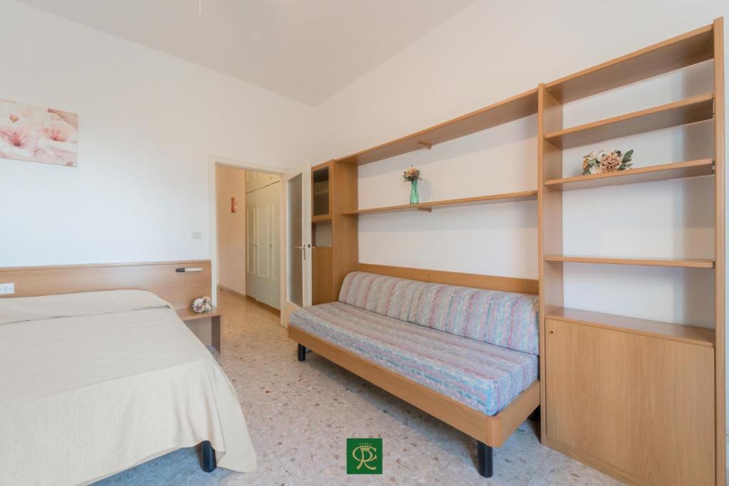 A bed or beds in a room at Residence Baia di Norsi