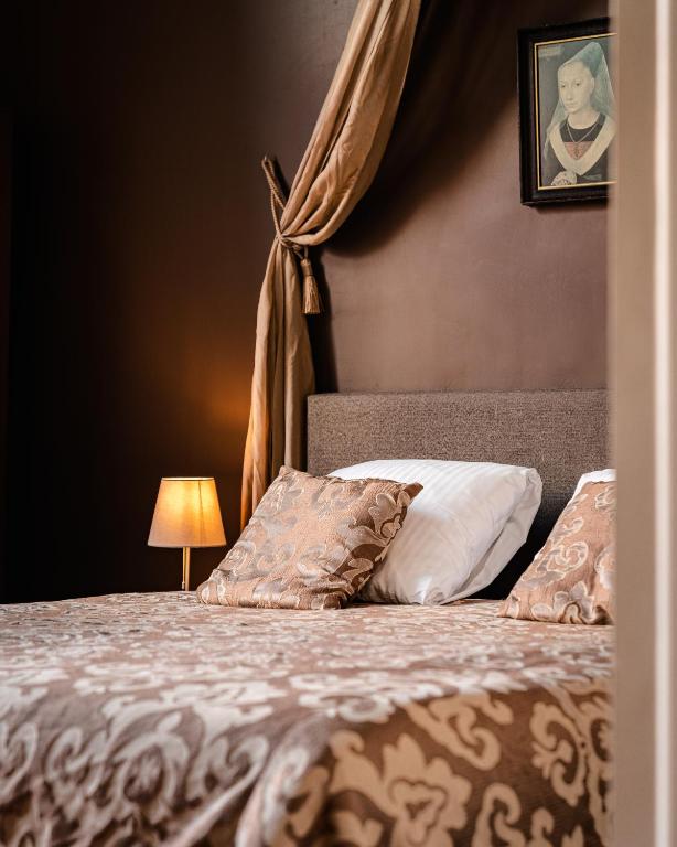 Postel nebo postele na pokoji v ubytování Hotel Van Eyck