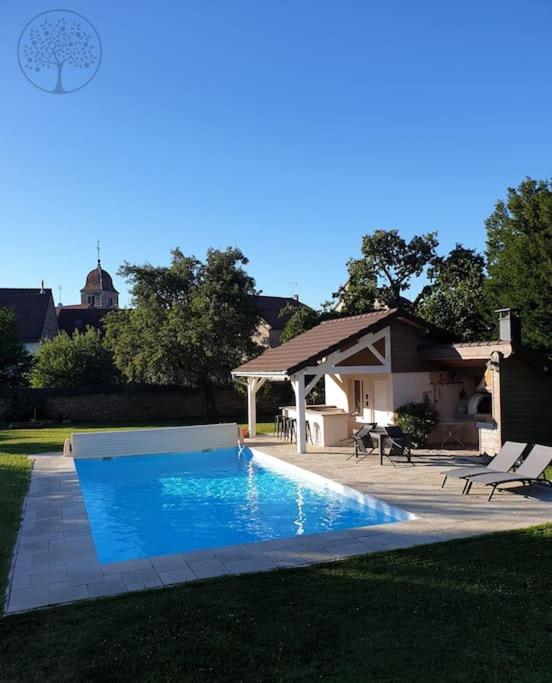 a swimming pool with a gazebo and a house at Guest house avec spa Jura , gîte du petit pommier 