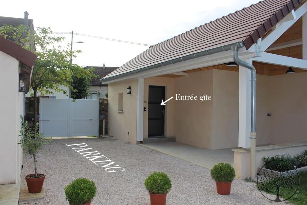 a garage with a building with a garage gate at Guest house avec spa Jura , gîte du petit pommier 