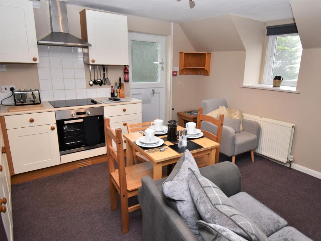 a kitchen and living room with a table and chairs at 2 Bed in Cosheston FB059 in Cosheston