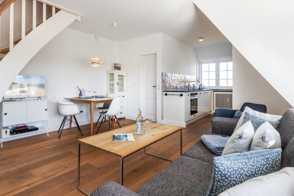 a living room with a couch and a table at Blue Haven in Keitum