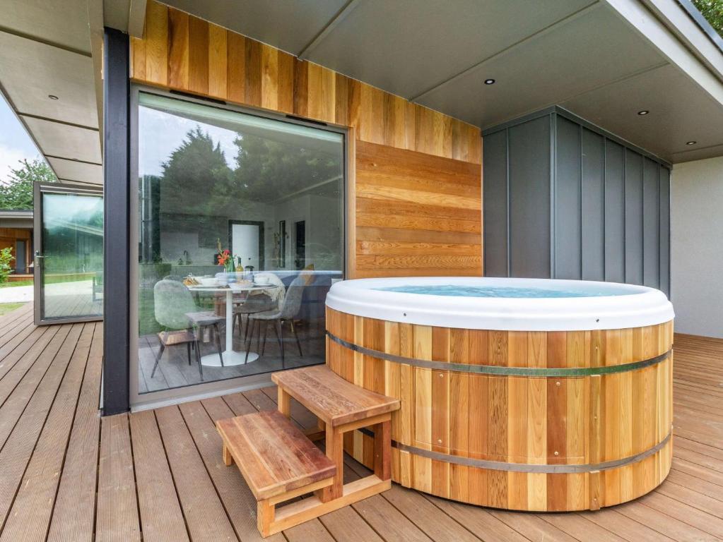 a hot tub on the deck of a house at 2 Bed in East Bergholt 82397 in East Bergholt