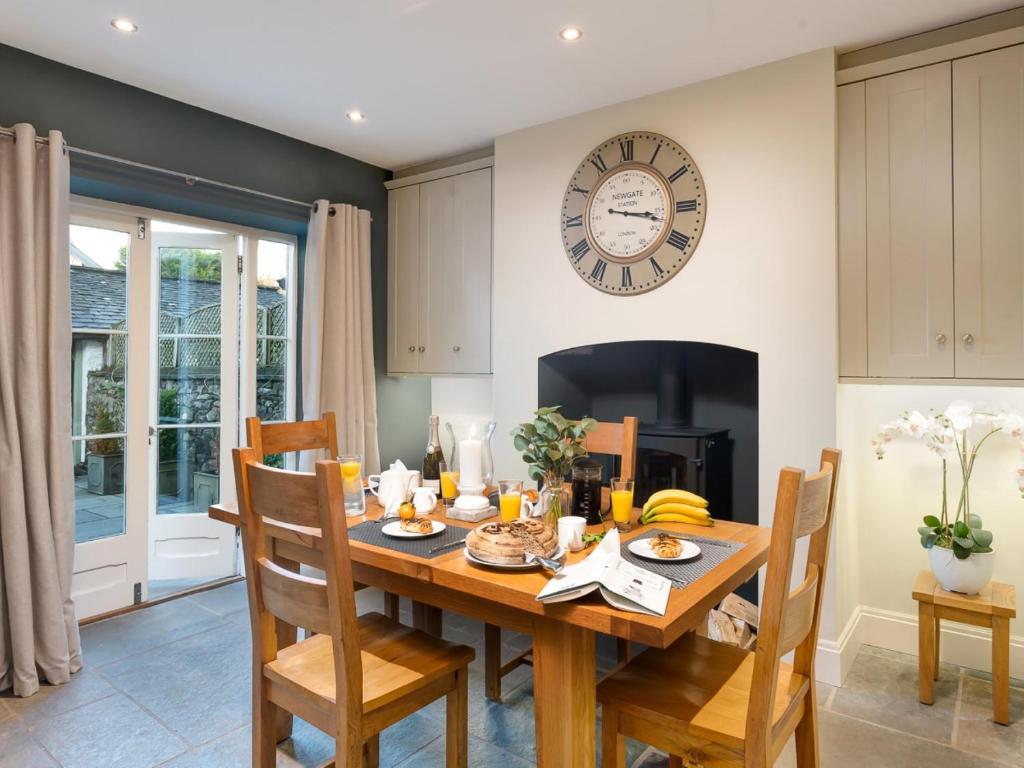 a dining room with a table and a clock on the wall at 2 Bed in Cartmel 83546 in Cartmel