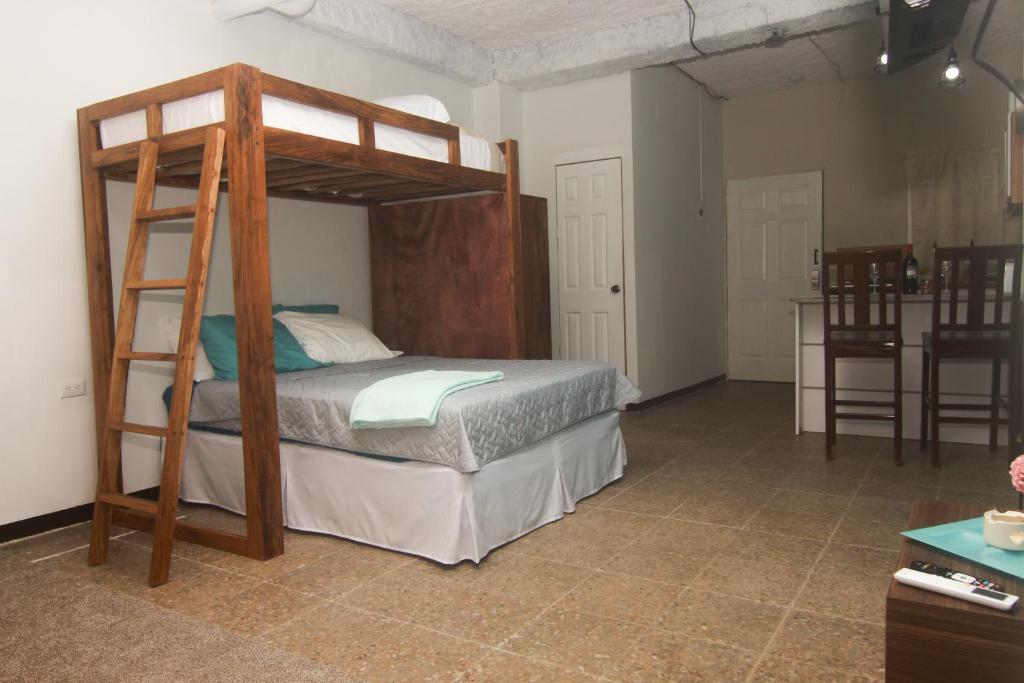 a bedroom with a bunk bed with a ladder at Sunset View - Mini Loft in La Libertad