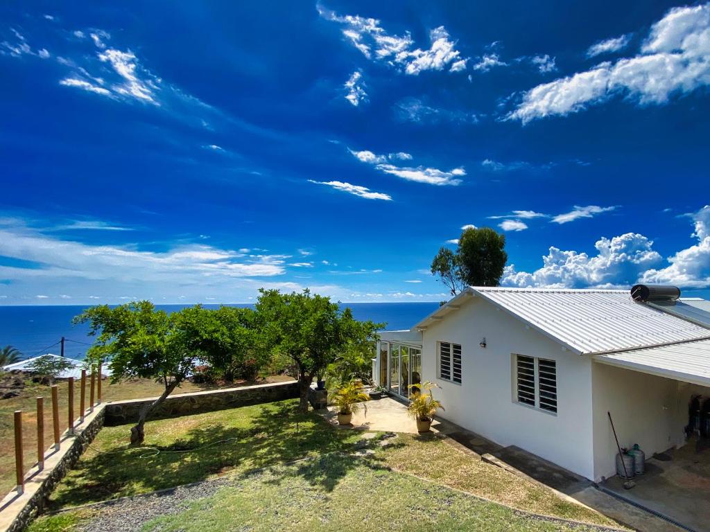 a white house with a view of the ocean at Villa détente vue mer st leu 6 personnes in Saint-Leu