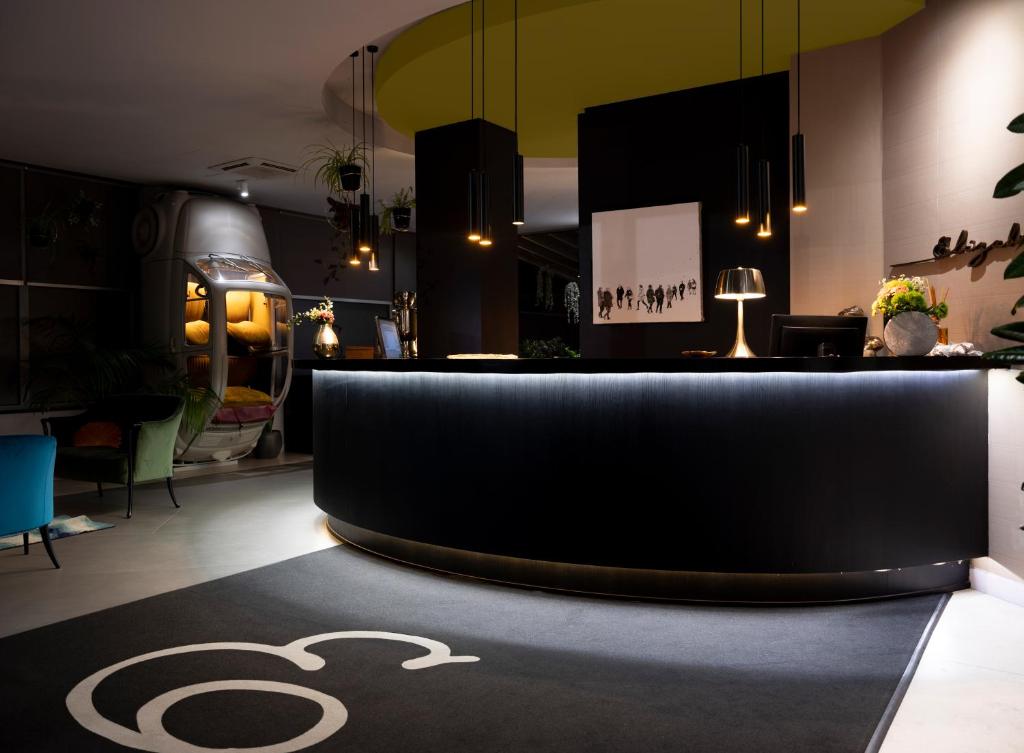 a lobby with a black carpet with a symbol on it at Elizabeth Lifestyle Hotel in Bologna