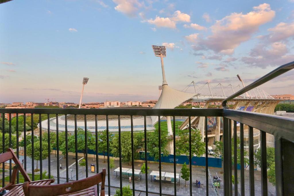 a balcony with a view of a baseball stadium at BEL APPARTEMENT PARISIEN PARC MONTSOURIS in Paris