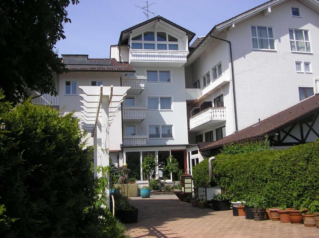 a large white building with plants in front of it at Arthotel Ana Panorama in Marktoberdorf