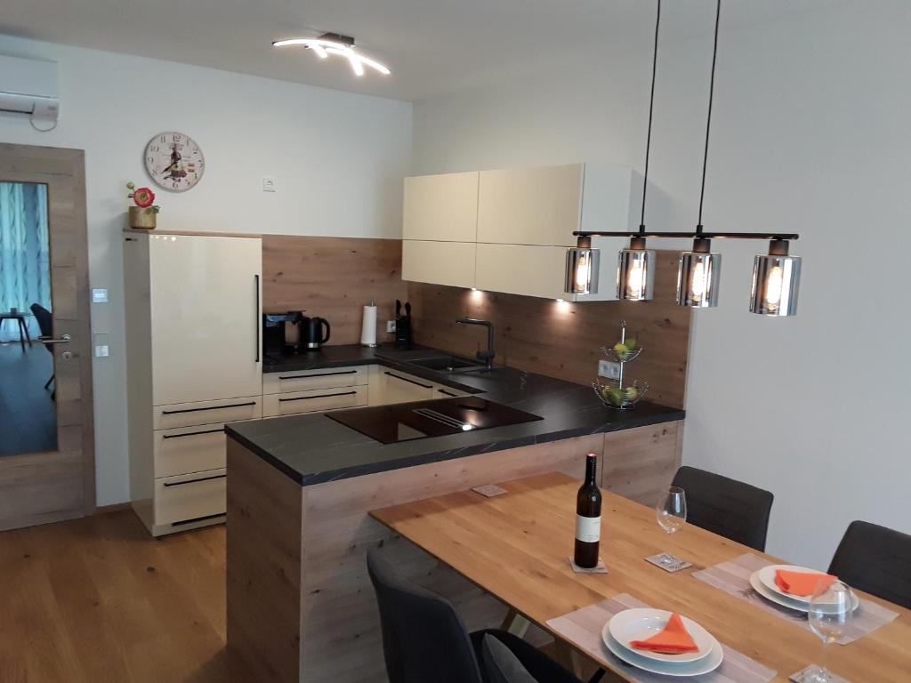 a kitchen with a table and a counter top at Apartment Kristall Real in Bad Radkersburg