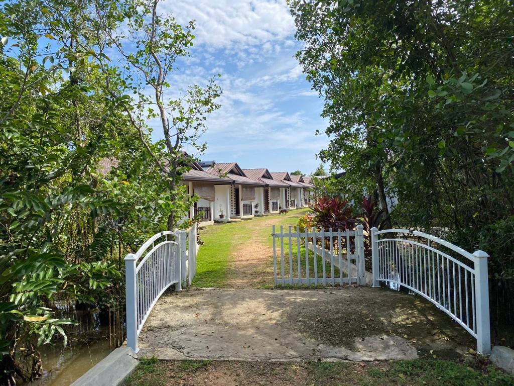 a white fence in front of a row of houses at Bali Villa Mirissa in Mirissa