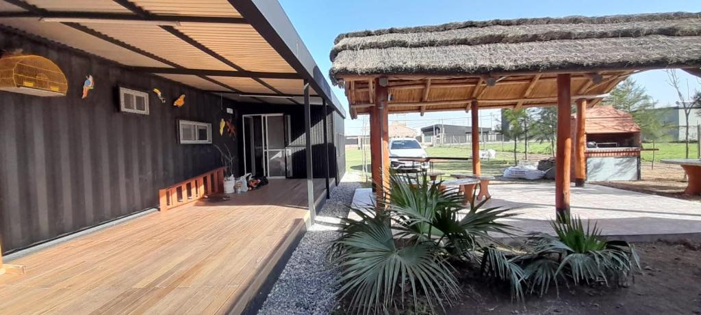 a porch of a house with a wooden deck at Hostal del Sol Rosario in Rosario