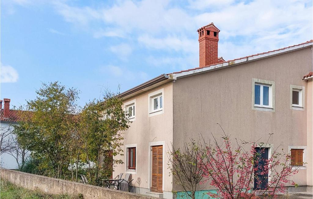 una casa con una chimenea de ladrillo encima en Amazing Home In Krsan With Kitchen, en Kršan