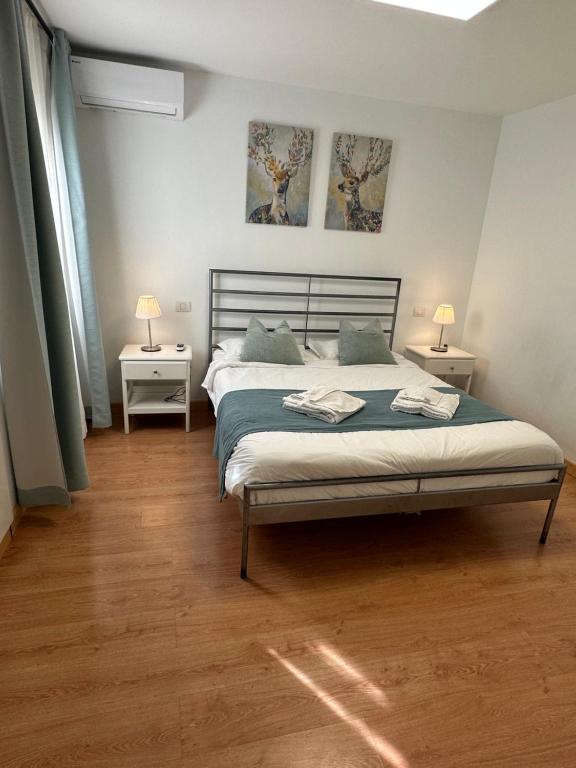 a bedroom with a bed with two tables and two lamps at Apartamento Olivin in Puerto del Carmen