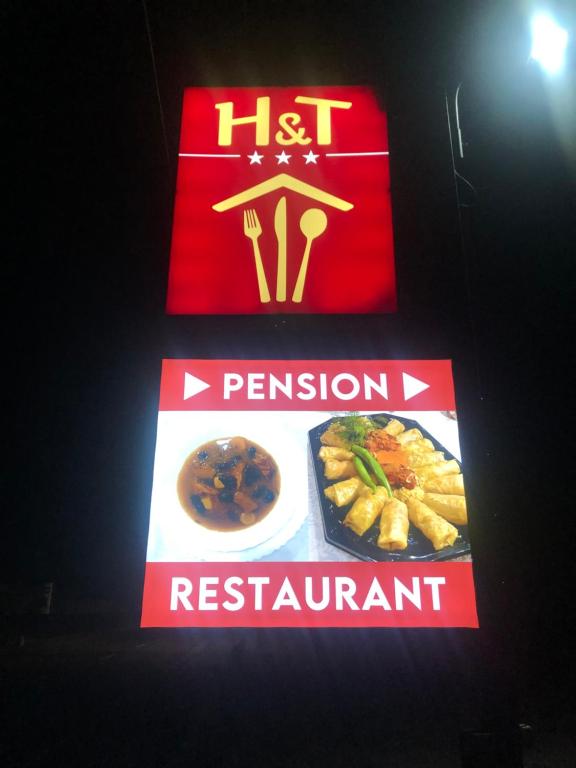 a sign for a restaurant with some food on it at H&T Pension-Restaurant in Jigodinu