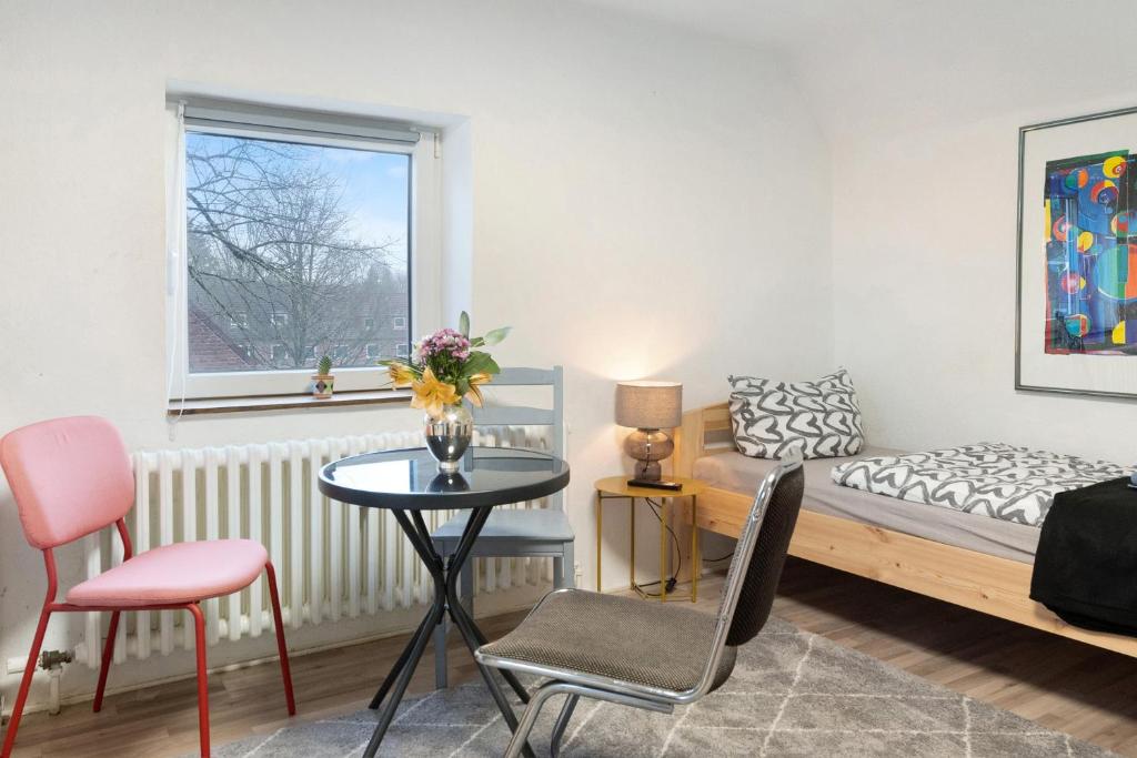 sala de estar con cama, mesa y sillas en Kiel Elmschenhagen Ostufer, en Kiel