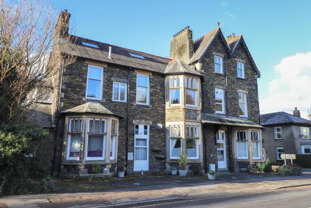 an old brick house on the corner of a street at Wansfell Loft in Ambleside