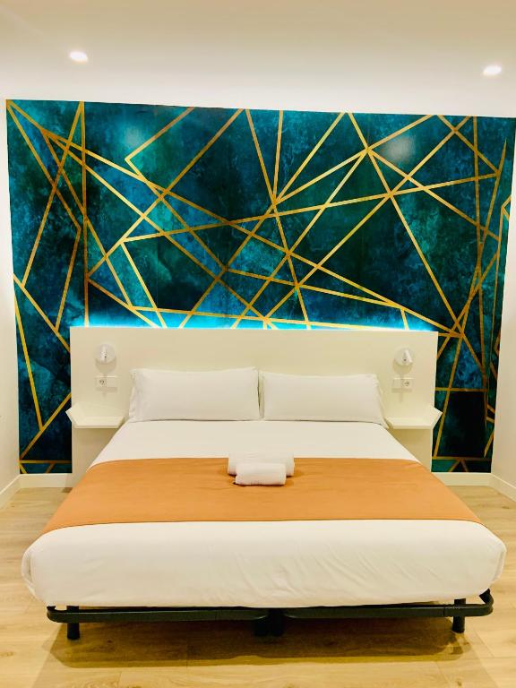 A bed or beds in a room at Hostal Abadia Madrid