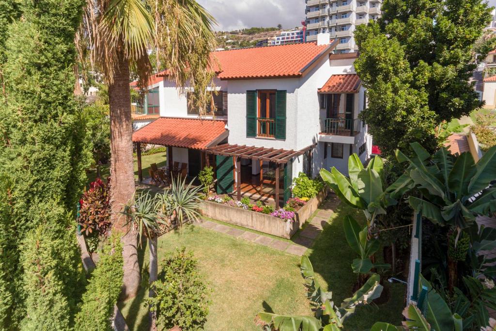 an aerial view of a house with a palm tree at Casa do Lido by An Island Apart in Funchal