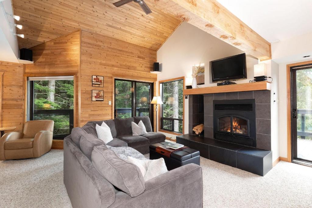 a living room with a couch and a fireplace at Telemark 14 - Townhome with a View, 5 Minute Walk to Village - Whistler Platinum in Whistler