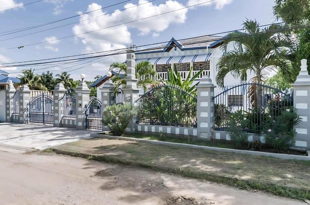 a white fence in front of a house at Joyful Ambiance Retreat 