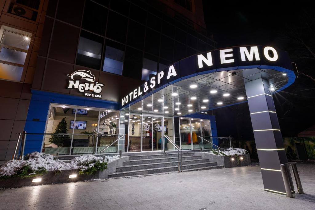 a nigerian nomo building at night at Hotel & Spa NEMO with dolphins in Kharkiv