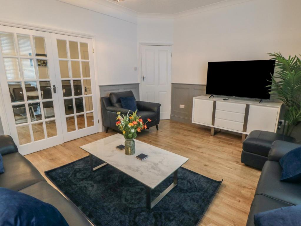 a living room with a couch and a table and a tv at 87 Columbus Ravine in Scarborough