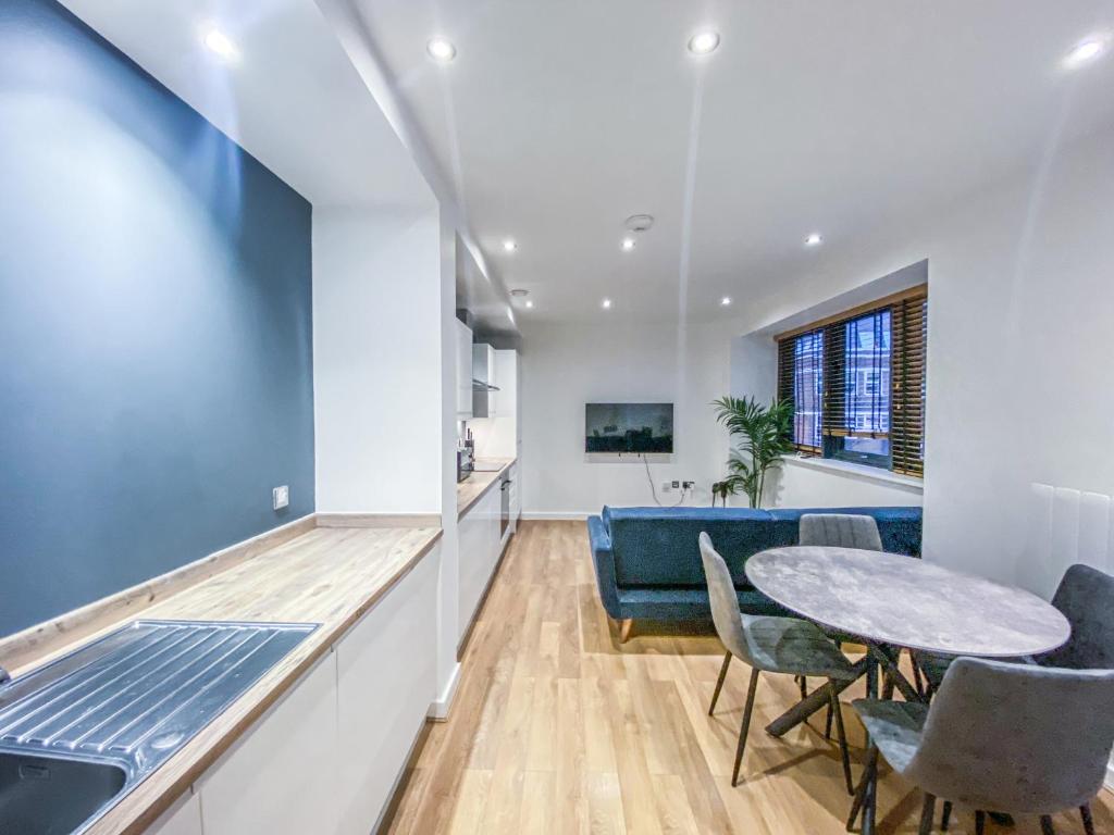 Il comprend une cuisine et un salon avec une table et des chaises. dans l'établissement Cathedral View Apartments by Elegance Living, à Peterborough