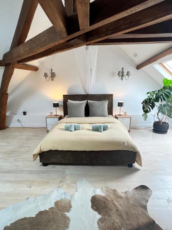a bedroom with a large bed and wooden ceilings at Maison de Haouret in Libaros