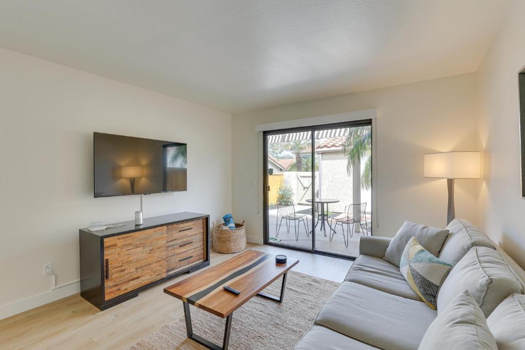 a living room with a couch and a tv at Bright Townhome in Carlsbad 1 Mile to Beach! in Carlsbad