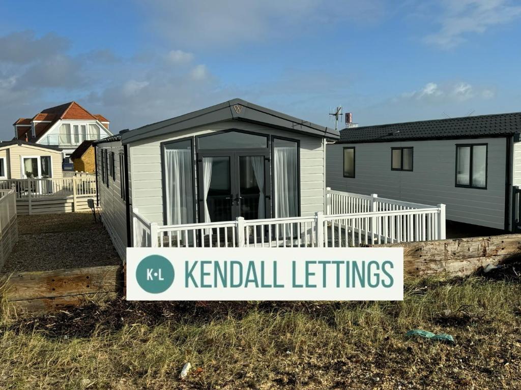 a sign in front of a house with a k rental letting sign at Sea View Lodge in Selsey