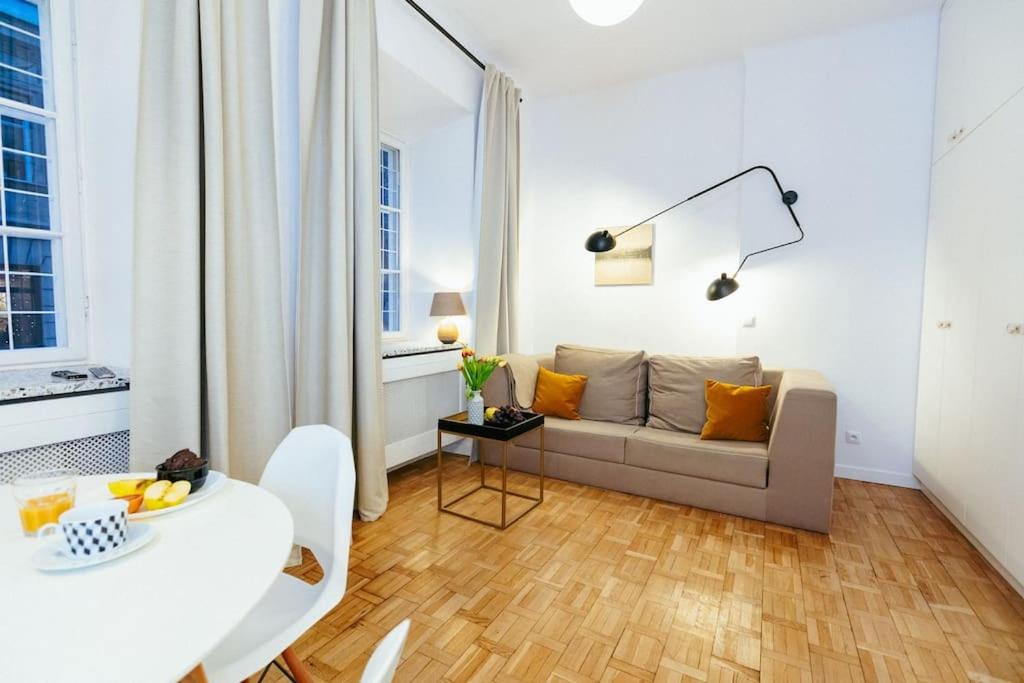 a living room with a couch and a table at Charming apartment next to the Old Town! in Warsaw