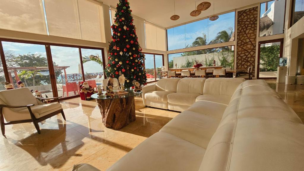 a large living room with a christmas tree in it at Villa Azul Maya in Isla Mujeres