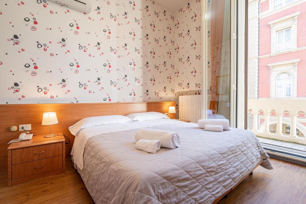 Postel nebo postele na pokoji v ubytování Hotel Donatello