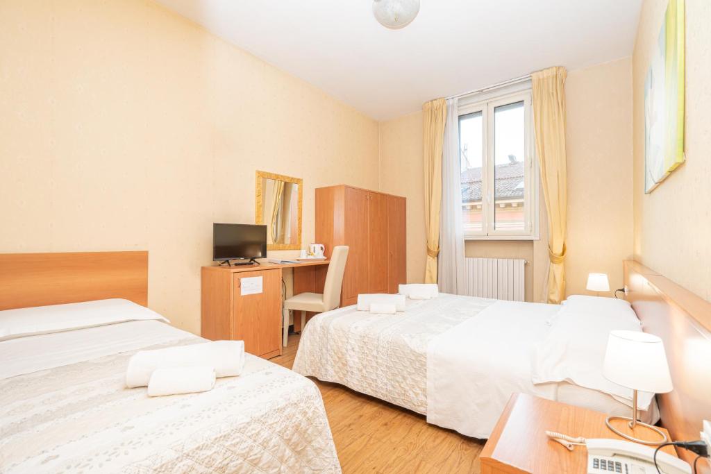 Postel nebo postele na pokoji v ubytování Hotel Donatello
