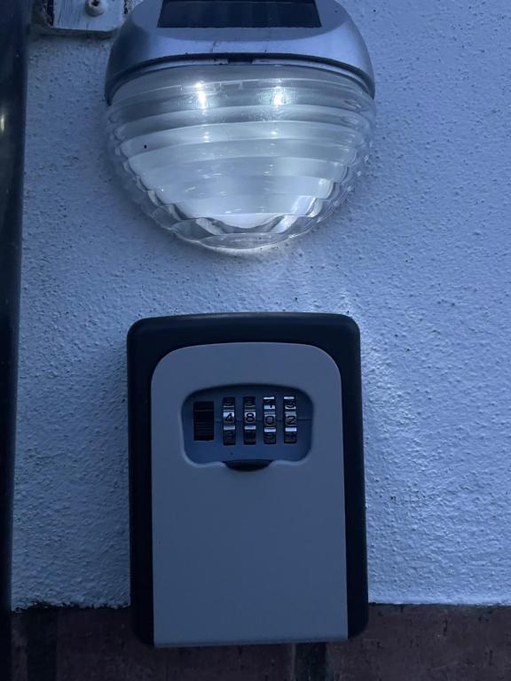 a close up of a soap dispenser on a wall at The Maiden Studio. Derry city. Studio Apartment. in Derry Londonderry