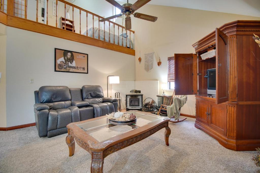 a living room with a couch and a table at Tahlequah Duplex with Screened-in Porch and Fire Pit! in Tahlequah