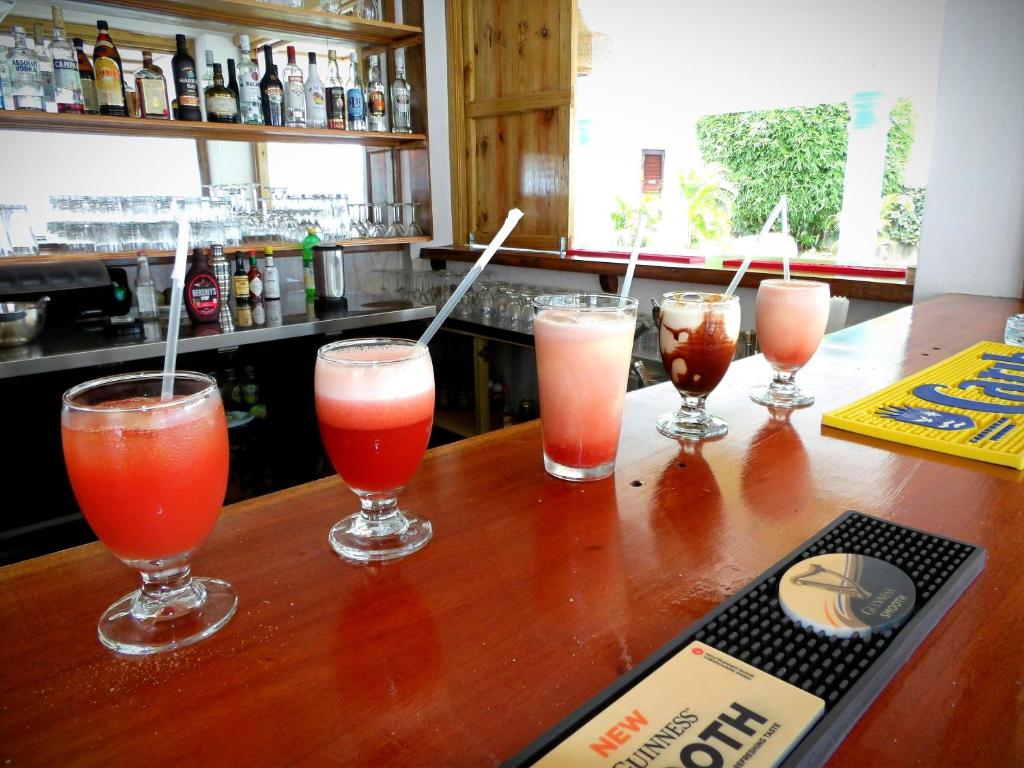 a group of four drinks sitting on a bar at Basil At Villa in Arnos Vale