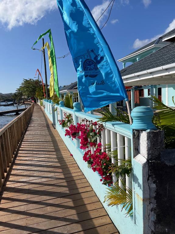 a boardwalk with a flag and flowers on it at Basil At Villa in Arnos Vale