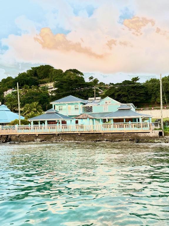 a building on a pier next to the water at Basil At Villa in Arnos Vale