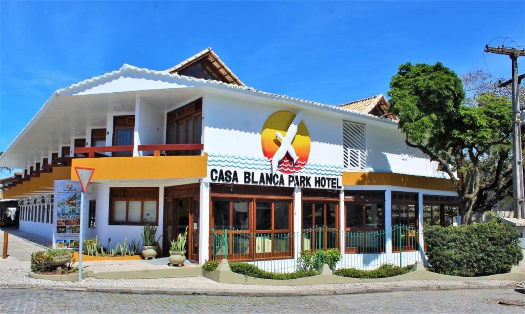 a building with a sign on the front of it at Casa Blanca Park Hotel in Porto Seguro