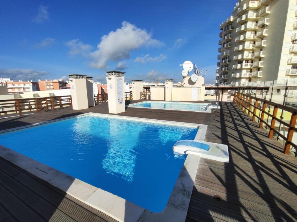 a swimming pool on the roof of a building at Armação de Pêra Ocean Terrace With Pool by Homing in Armação de Pêra