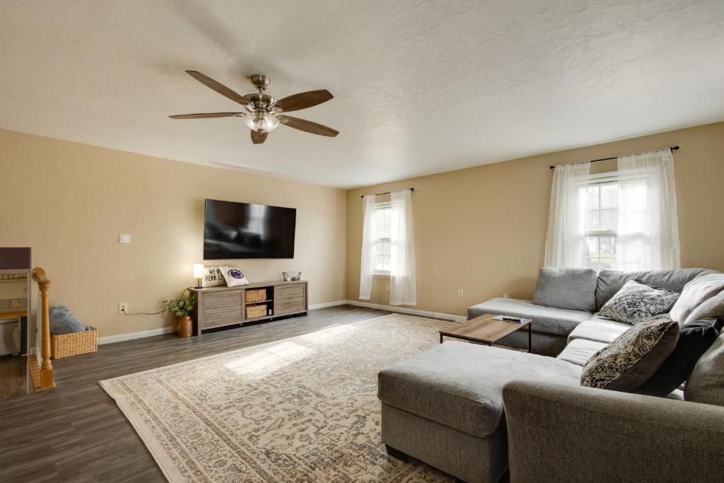 a living room with a couch and a ceiling fan at Charming State College Home - 4 Mi to PSU! in State College