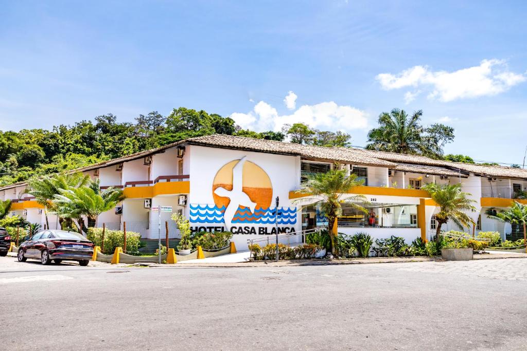 a building with a sign on the side of it at Hotel Casa Blanca Porto Seguro in Porto Seguro