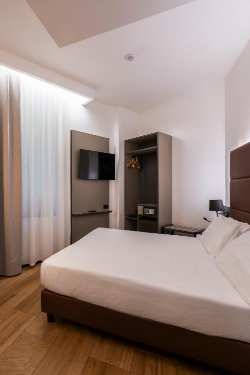 Postel nebo postele na pokoji v ubytování London Hotel