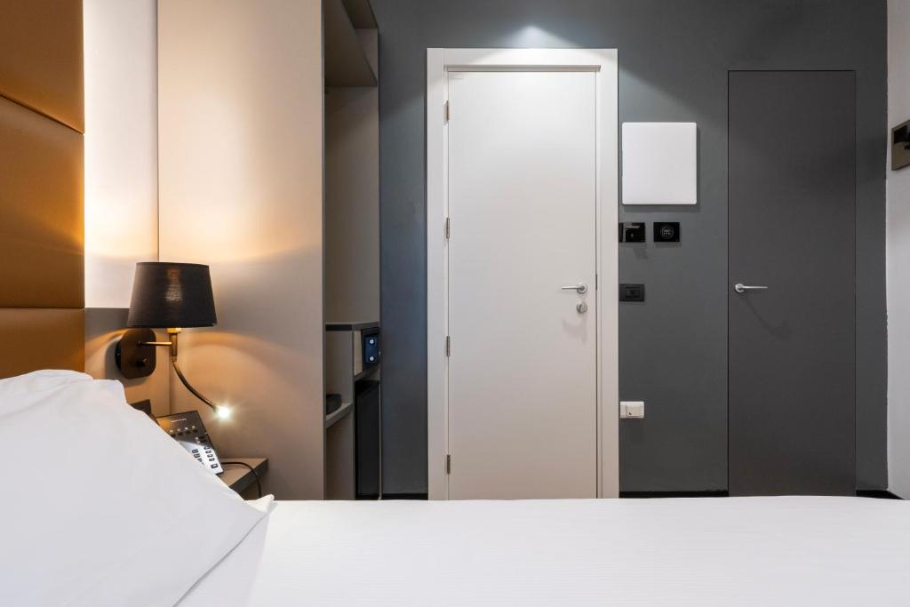 Postel nebo postele na pokoji v ubytování London Hotel