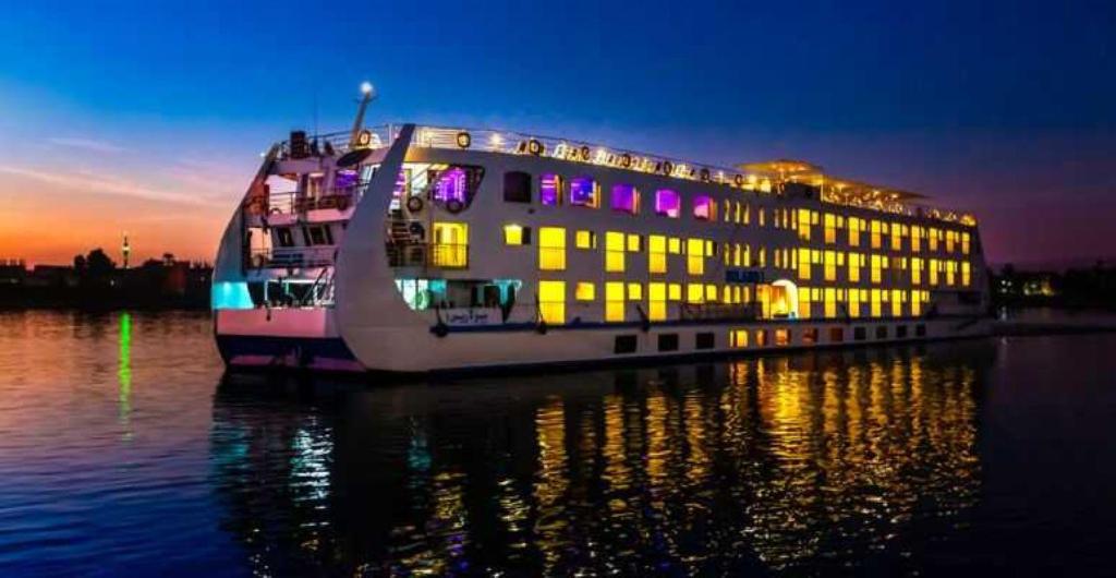 a cruise ship in the water at night at Horus Eye Nile Cruse in Luxor