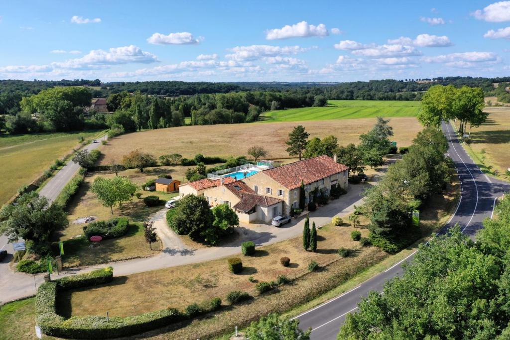 an aerial view of a house in a field at Logis Hôtel La Ferme de Flaran in Maignaut